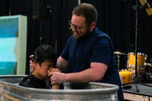 Dave Elliff baptizes a believer during a Sunday morning service