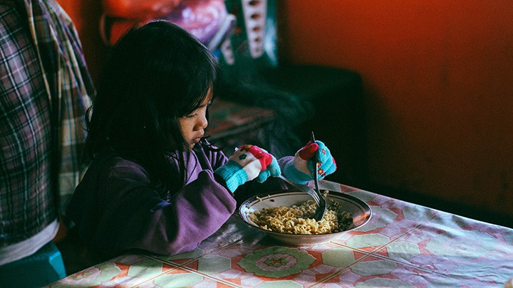 Child eats noodles
