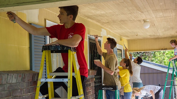 Young adults painting walls