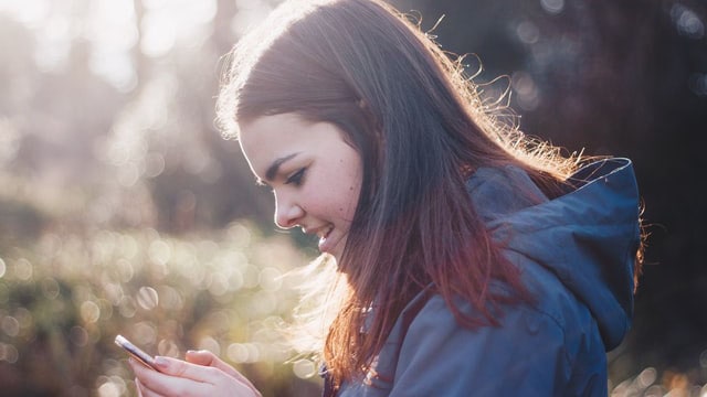 Young woman reading phone