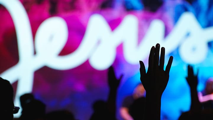 Silhouette of hands raised in worship