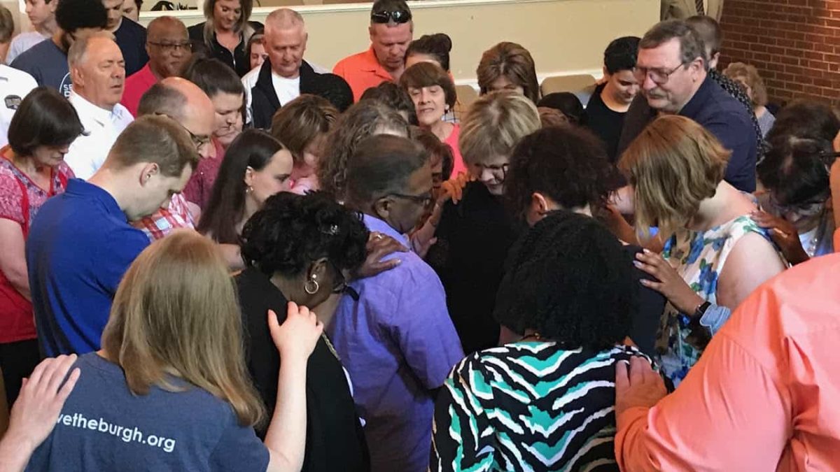 Members of Rolling Hills pray over Jeff Dawson and Connie Kelly