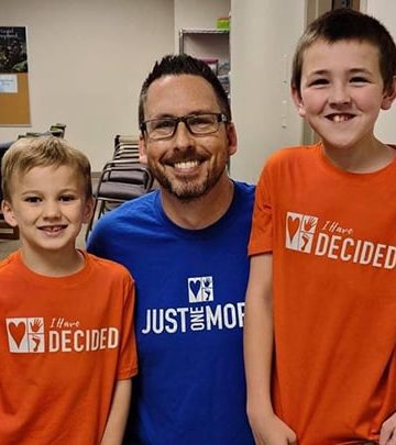 Pastor Ryan Day and two youth who were baptized