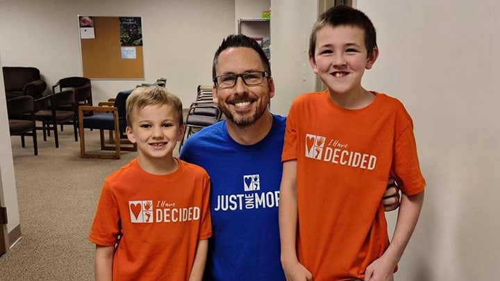 Pastor Ryan Day and two youth who were baptized