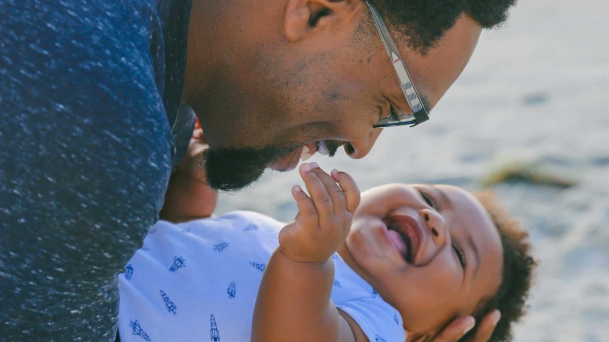 Father holding laughing baby