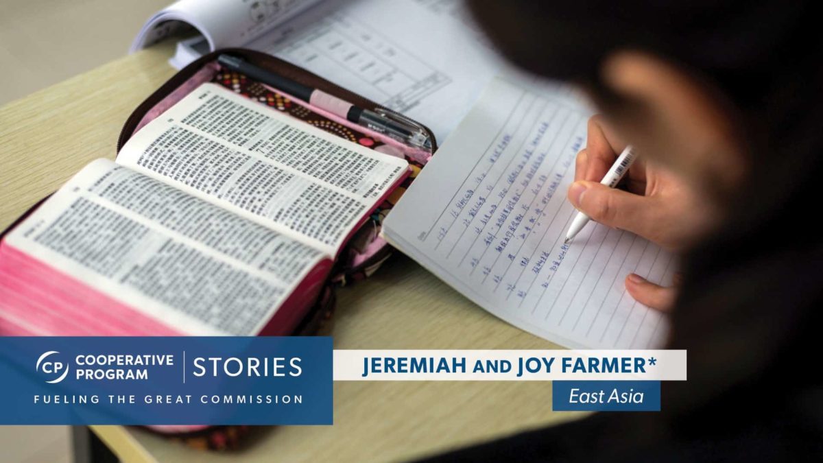 An individual writing notes from Bible