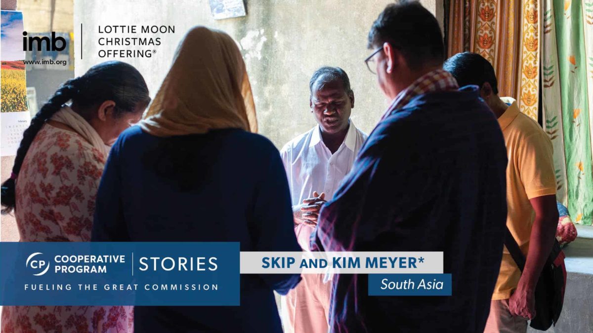 Missionaries praying with South Asian couple