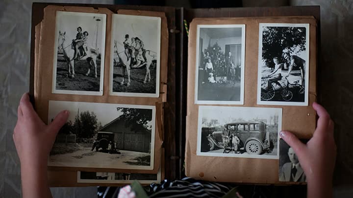 Boy looking at old family photos